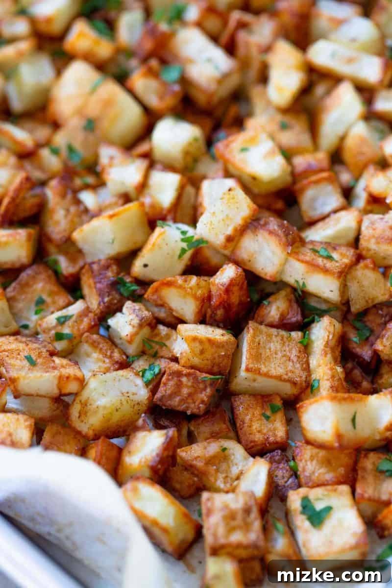 Golden Roasted Five Spice Potatoes 6 Deliciously roasted five spice potatoes, garnished with fresh parsley, presented on a white plate.
