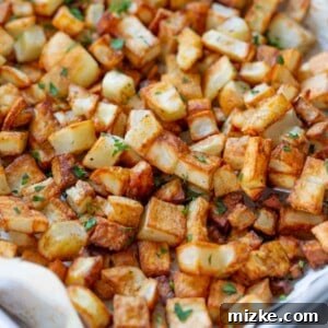 Beautifully roasted five spice potatoes, garnished with fresh herbs, presented in a recipe card format.