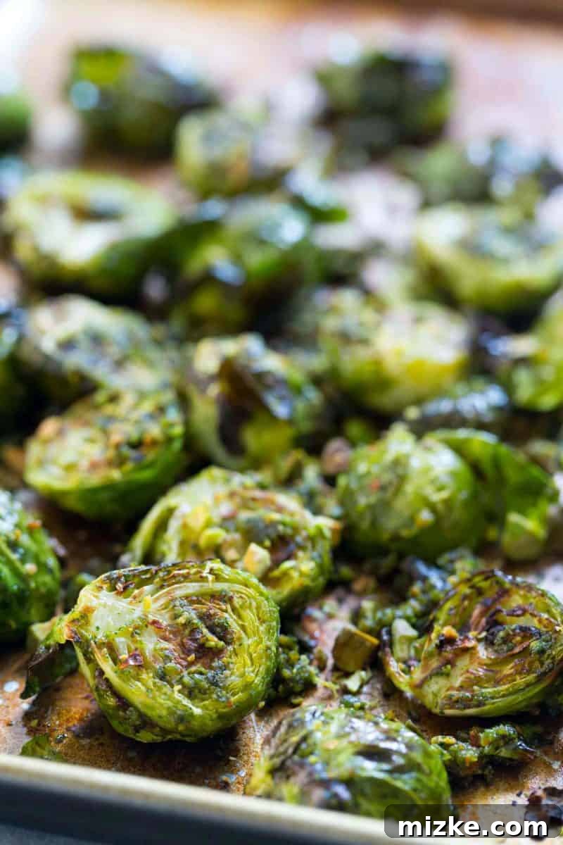 Leftover roasted brussels sprouts in a container, ready for refrigeration.