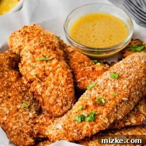 Crispy oven-baked chicken tenders on a plate.