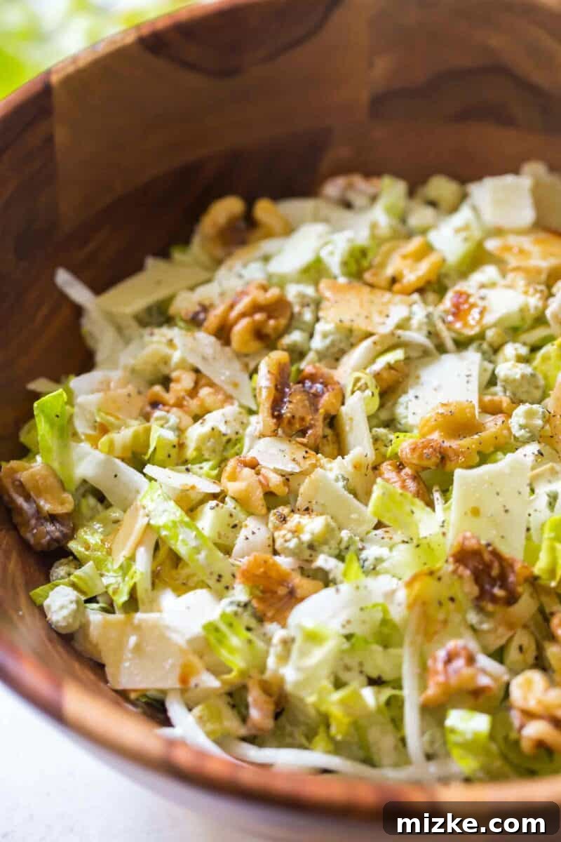 Dressed Endive and Romaine Salad A close-up of the dressed chopped endive and romaine salad, highlighting the creamy texture and fresh ingredients.