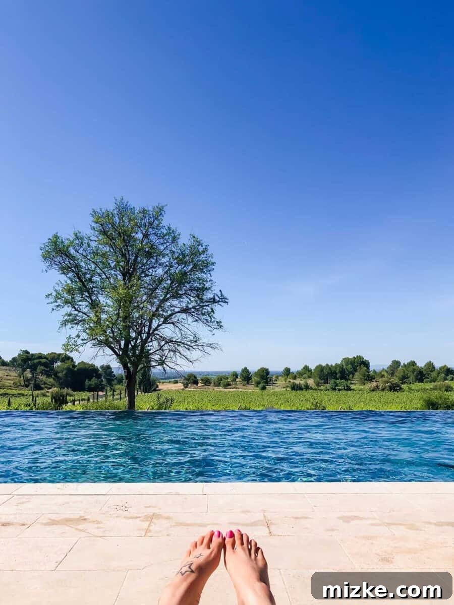 Relaxing poolside scene at Château les Carrasses, perfect for a luxurious Southern France chateau vacation.