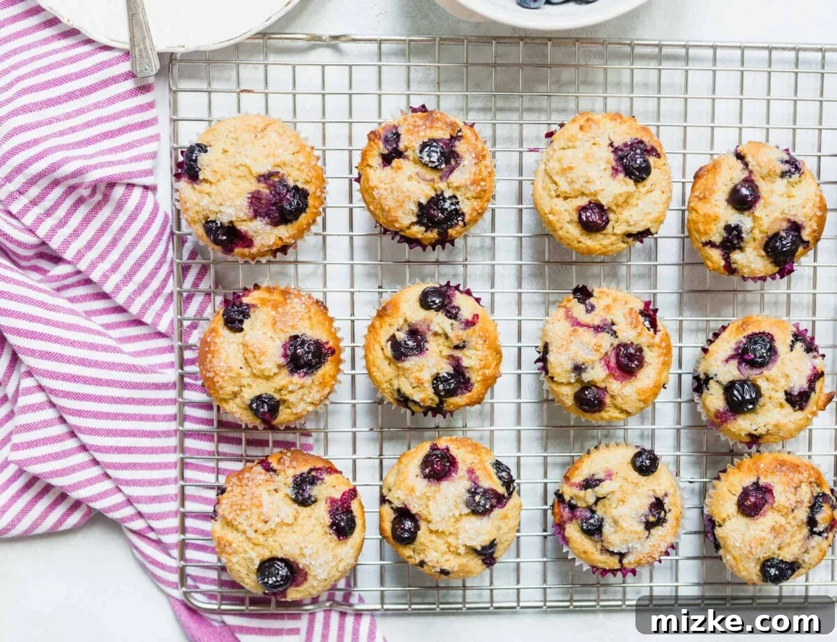 A delicious homemade blueberry muffin showcasing a perfect rise, tender interior, and abundant blueberries, captured to highlight its bakery-like quality.