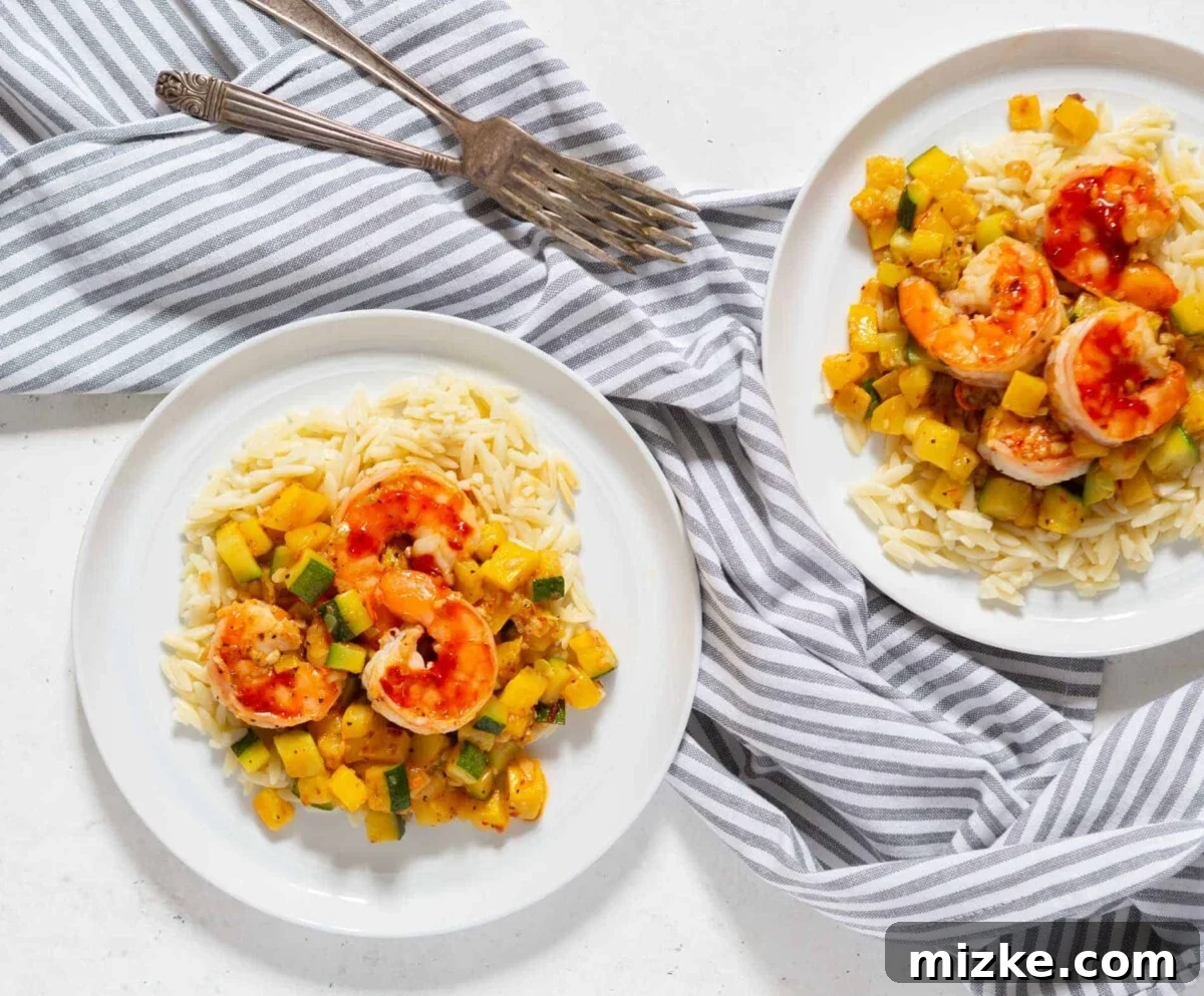 Delicious Shrimp and Zucchini Orzo for a Fast Dinner A vibrant bowl of Shrimp and Zucchini Orzo, featuring succulent shrimp, bright green zucchini pieces, and delicate orzo pasta, perfect for a quick and easy weeknight dinner.