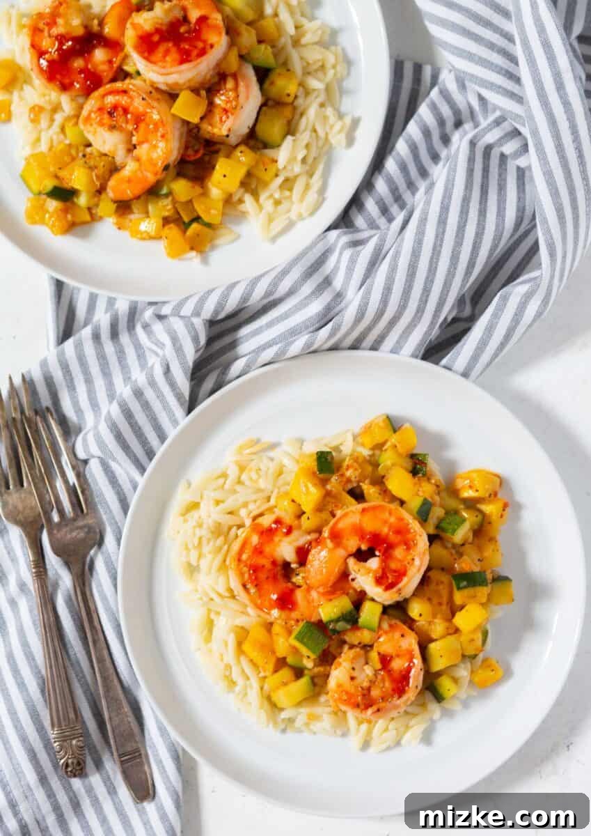 Quick & Easy Shrimp Zucchini Orzo Close-up of the cooked Shrimp and Zucchini Orzo dish, showcasing the perfectly cooked shrimp, tender zucchini cubes, and glossy orzo pasta, ready to be served.
