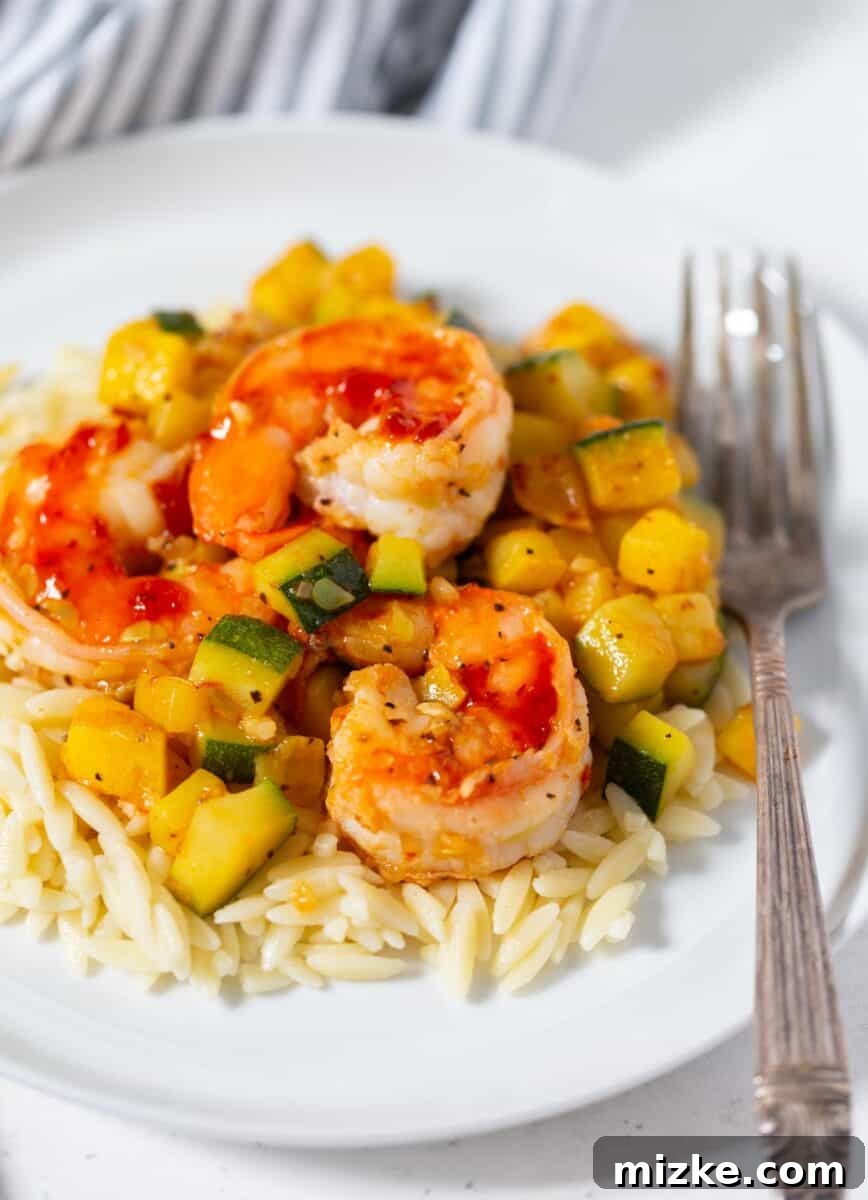 Shrimp Orzo with Fresh Zucchini A close-up shot of the Shrimp and Zucchini Orzo, highlighting the texture of the orzo, the sear on the shrimp, and the vibrant green of the zucchini pieces.