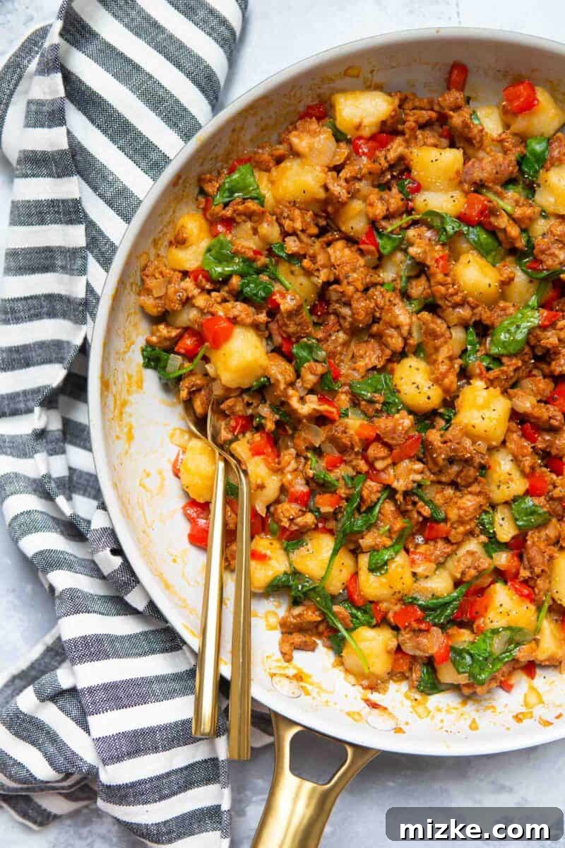 Closeup of the finished chicken chorizo cauliflower gnocchi skillet, showcasing its vibrant ingredients.