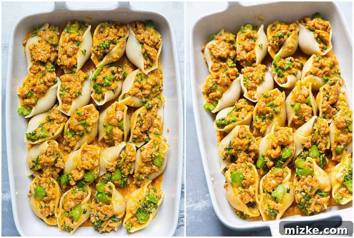 An unbaked casserole dish of pumpkin stuffed shells, arranged neatly and ready for the oven, showcasing the filling and preliminary sauce.