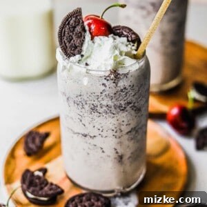 A finished Cookies and Cream Milkshake, garnished with whipped cream and an Oreo cookie, ready to be enjoyed.
