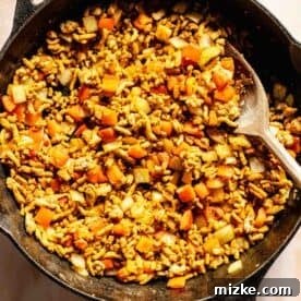 Savory Turkey Picadillo 6 Bell peppers and onions with the ground turkey mixture in the cast iron skillet, showcasing the addition of aromatics