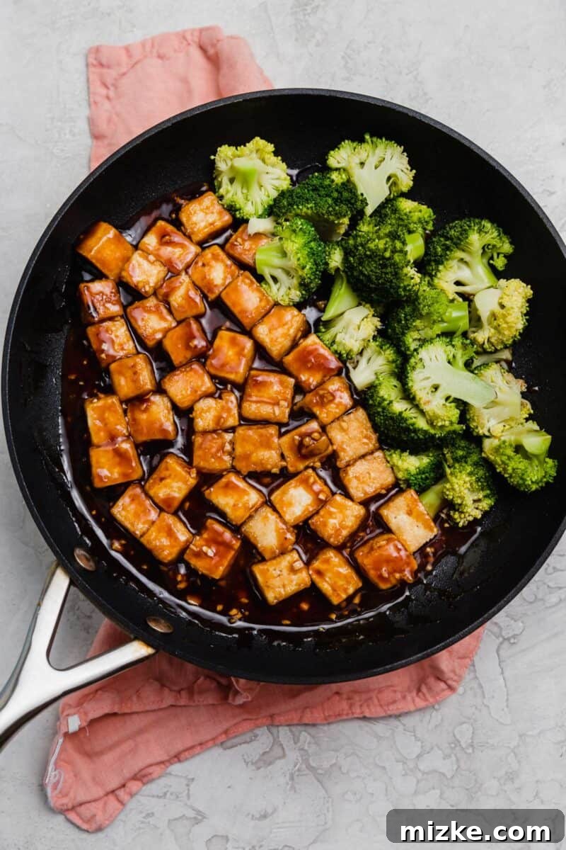 Teriyaki Tofu and Broccoli Power Bowls 2 Cubes of tofu and broccoli in a frying pan