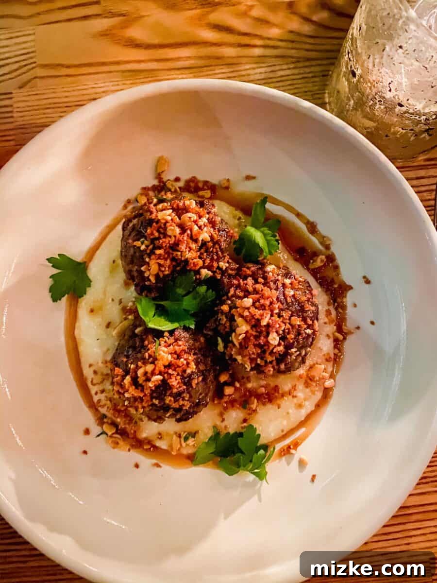 DC Date Night: Gala of Hearts 5 A close-up of the delectable dry-aged beef meatballs from Reveler's Hour, resting in a rich, savory sauce.