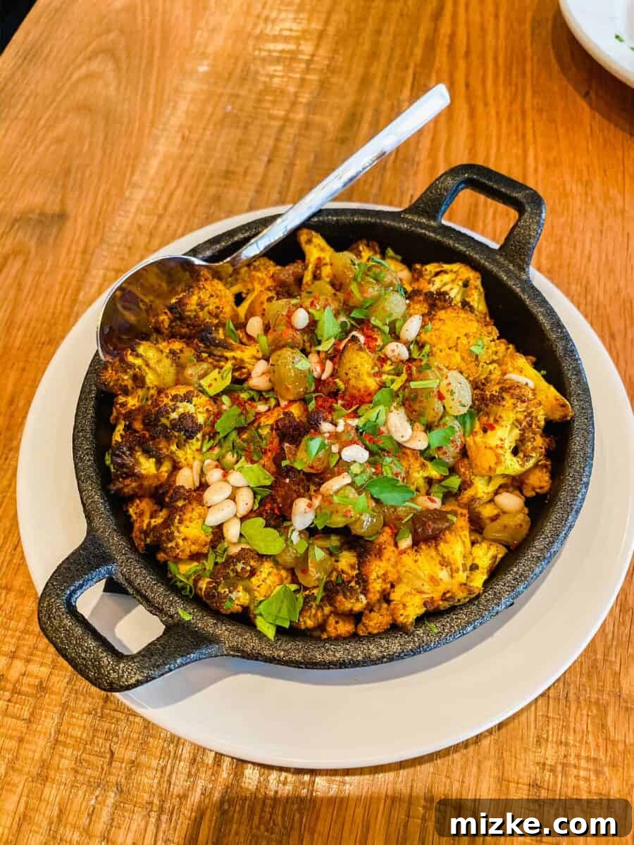 DC Date Night Done Right: Emmy Squared 6 A serving of roasted cauliflower florets, lightly charred, presented as a side dish, with a focus on its texture.