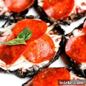 Close-up of a single mushroom pizza cap, perfectly grilled with melted cheese and pepperoni, topped with fresh basil