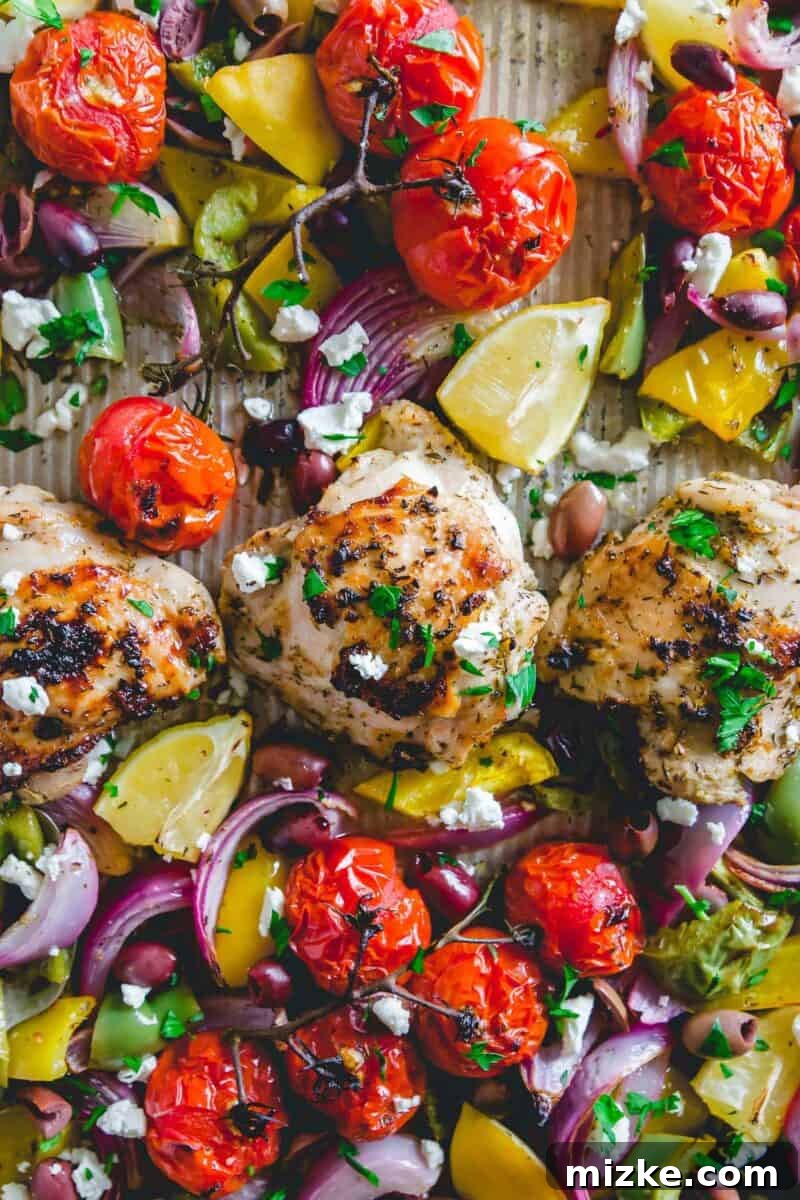 One Pan Greek Chicken Dinner 2 Delicious Sheet Pan Greek Chicken with roasted vegetables on a baking sheet