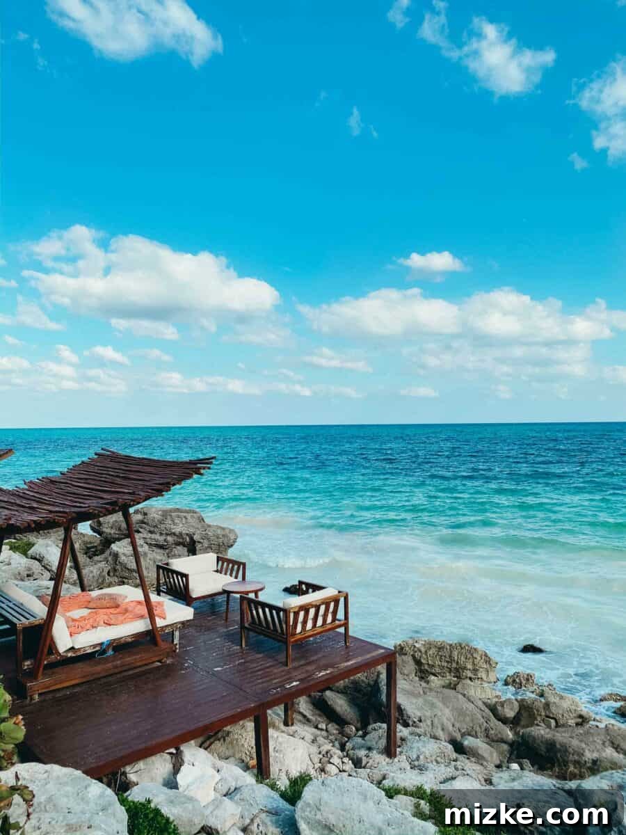 Tulum Vibes with My Tribe 2 Three friends enjoying a scenic view from a cliffside resort in Tulum, overlooking the ocean.