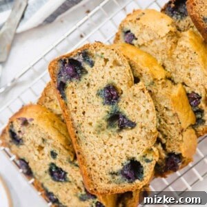 The finished blueberry banana bread, a slice on a plate.