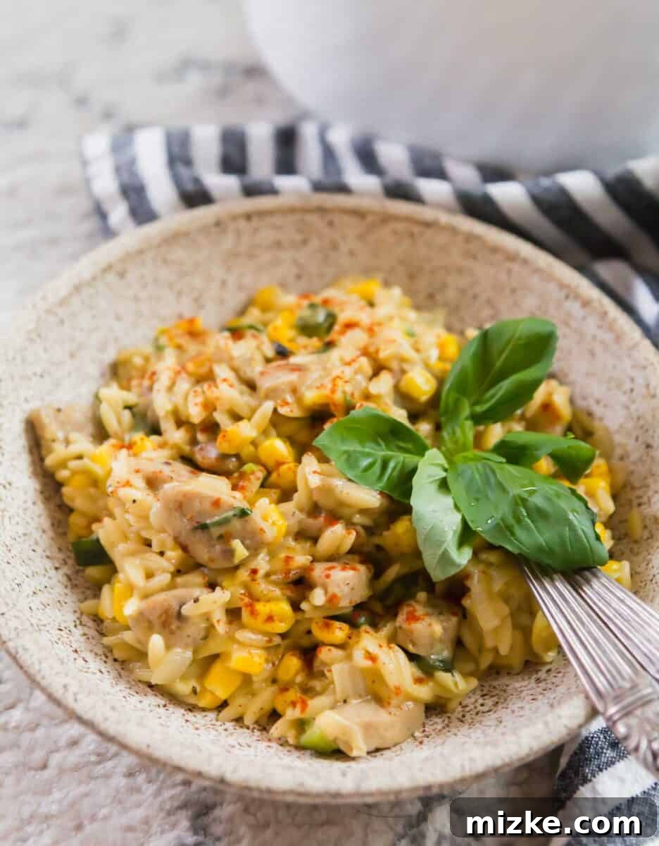 Close-up of a skillet filled with creamy poblano corn orzo, showcasing its rich texture.