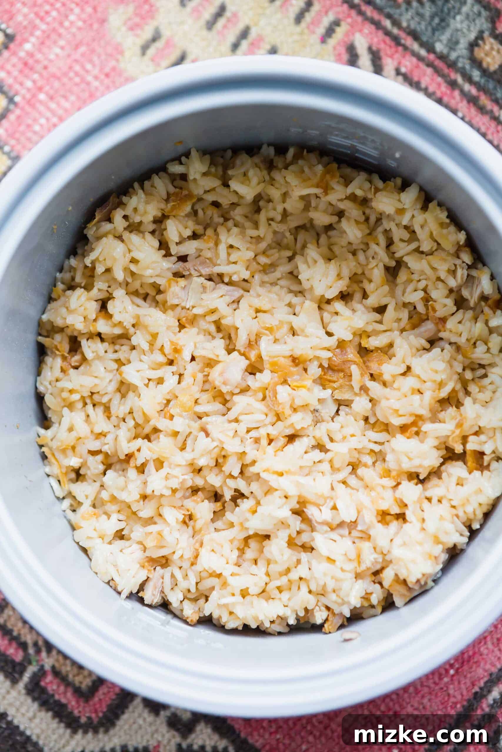 Crispy Chicken Rice Perfection 4 A beautifully presented bowl of freshly made Fried Chicken Rice, with shredded fried chicken mixed into the fluffy rice, showcasing its rich texture and inviting aroma. Perfect for a quick, satisfying meal.