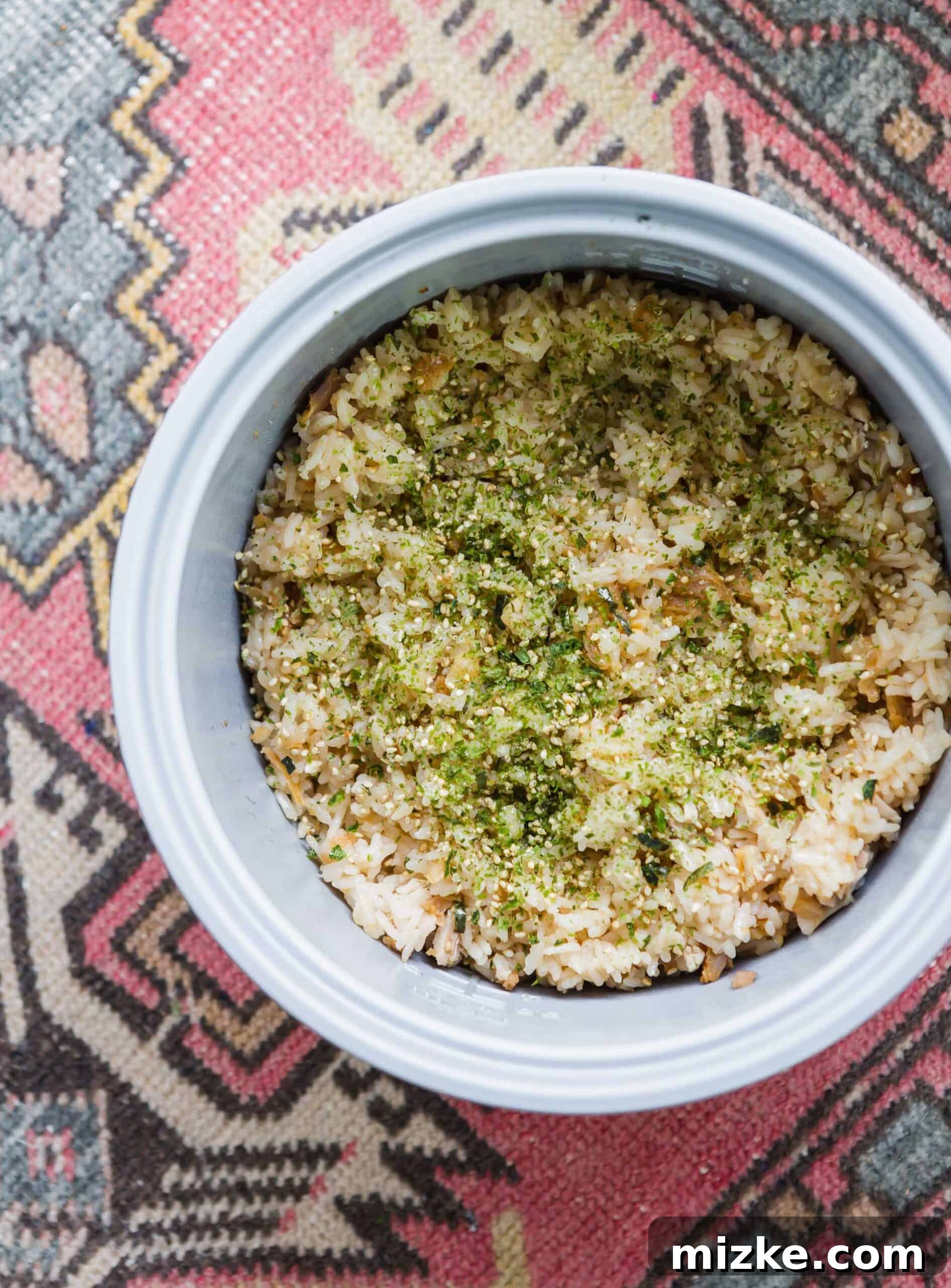 Crispy Chicken Rice Perfection 5 A generous serving of flavorful Fried Chicken Rice, elegantly garnished with furikake seasoning, highlighting its delicious appeal and readiness to be enjoyed as a quick and satisfying meal. The rice is perfectly cooked and infused with chicken goodness.