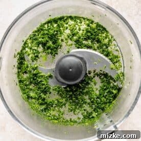 Mediterranean Turkey Spinach Feta Burgers 5 Fresh spinach finely chopped in a food processor bowl, ready to be mixed into the burger patties.