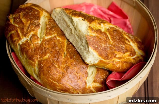 Zesty Mustard Butter Pretzel Baguette 3 A freshly baked pretzel baguette, golden brown and perfectly seasoned, ready to be sliced.