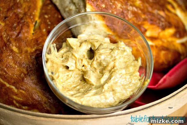 Zesty Mustard Butter Pretzel Baguette 4 Close-up of the pretzel baguette sliced and smothered with a rich, creamy mustard butter.