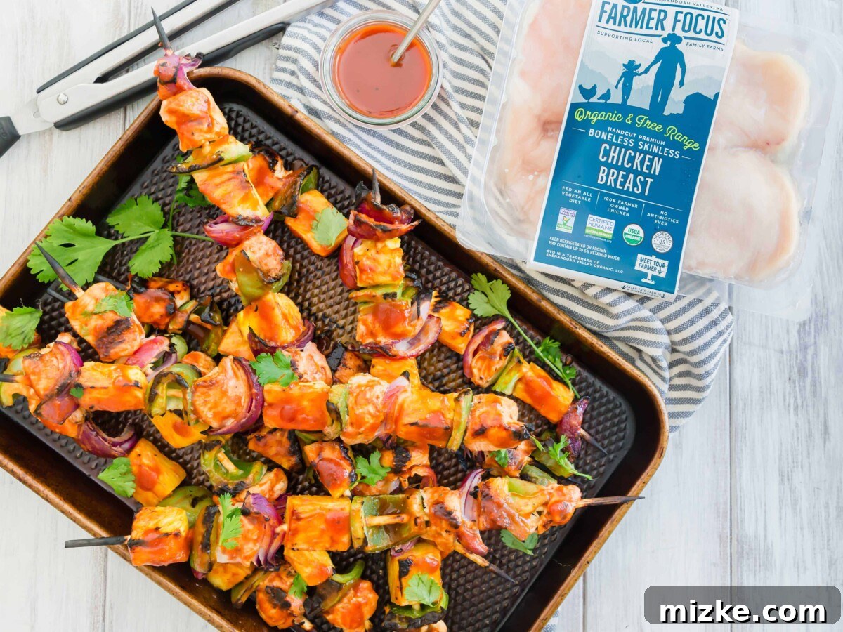 Tropical BBQ Chicken & Pineapple Skewers 2 Delicious grilled pineapple bbq chicken kabobs, glistening with sauce and perfectly charred, ready for a summer meal.