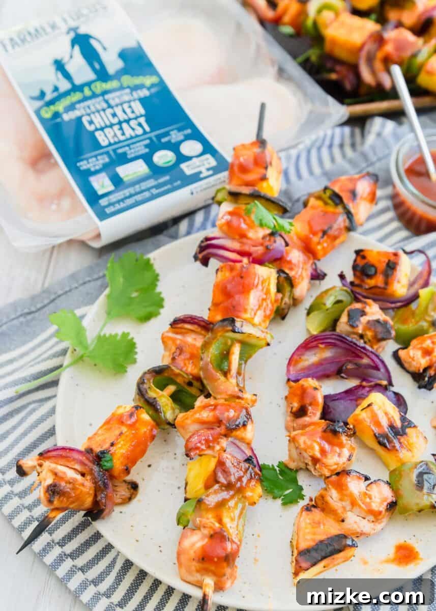 Tropical BBQ Chicken & Pineapple Skewers 5 A selection of grilled pineapple bbq chicken kabobs artfully arranged on a serving platter, perfect for a gathering.