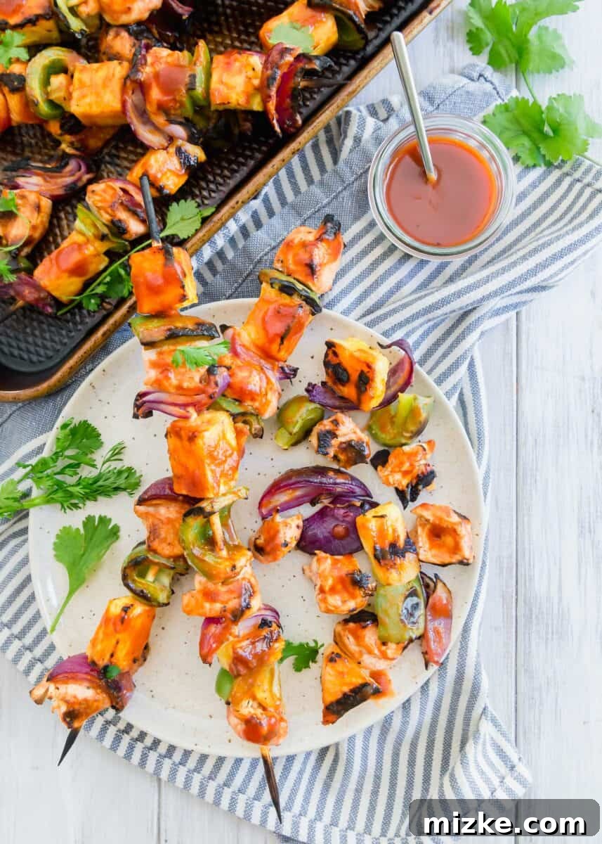 Tropical BBQ Chicken & Pineapple Skewers 6 A beautifully set outdoor table featuring grilled pineapple bbq chicken kabobs, salad, and other refreshing summer dishes.