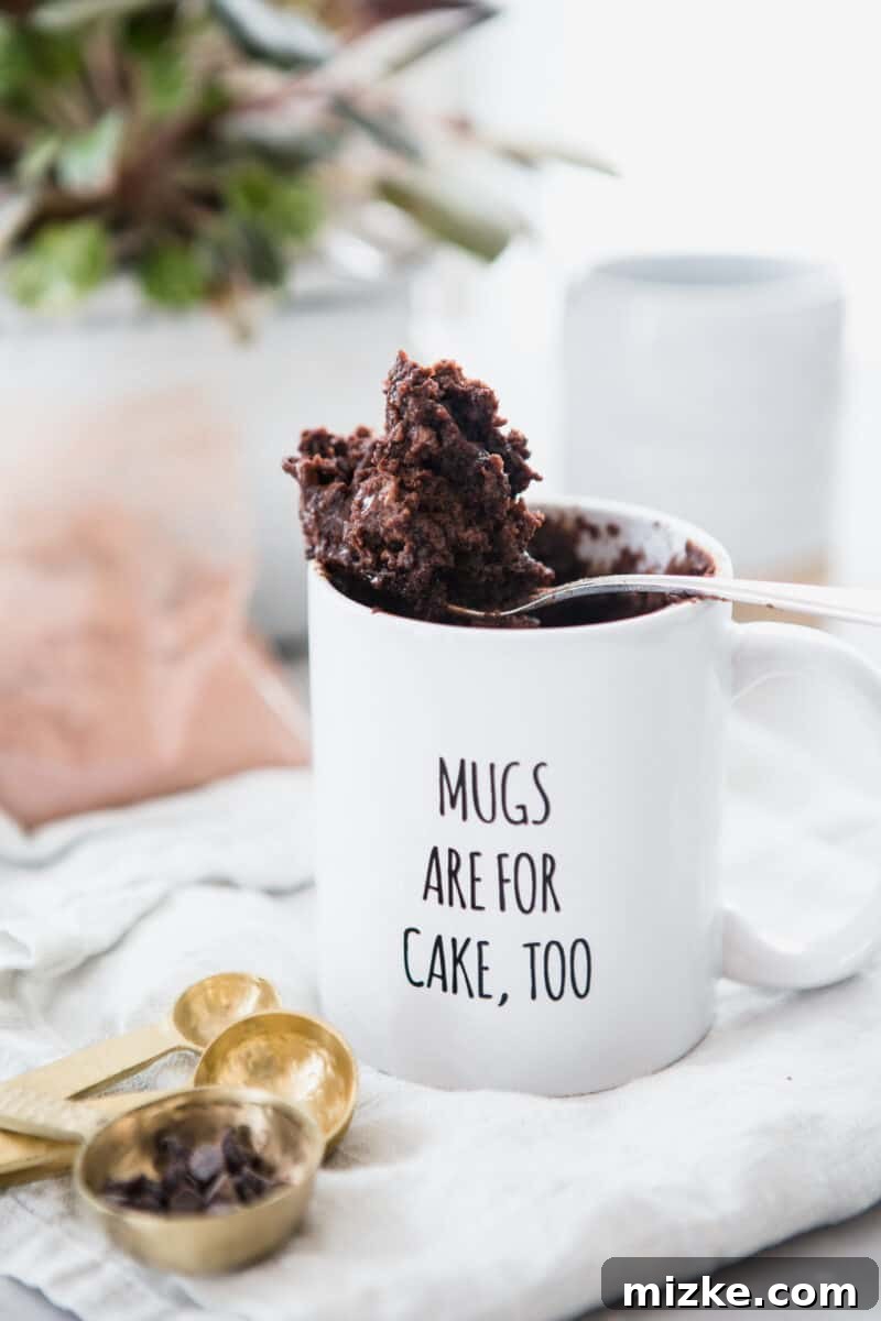 Table for Two: Chocolate Mug Cake Kit 7 A person wearing gloves and a hairnet, packaging the mug cake kits, emphasizing safety.