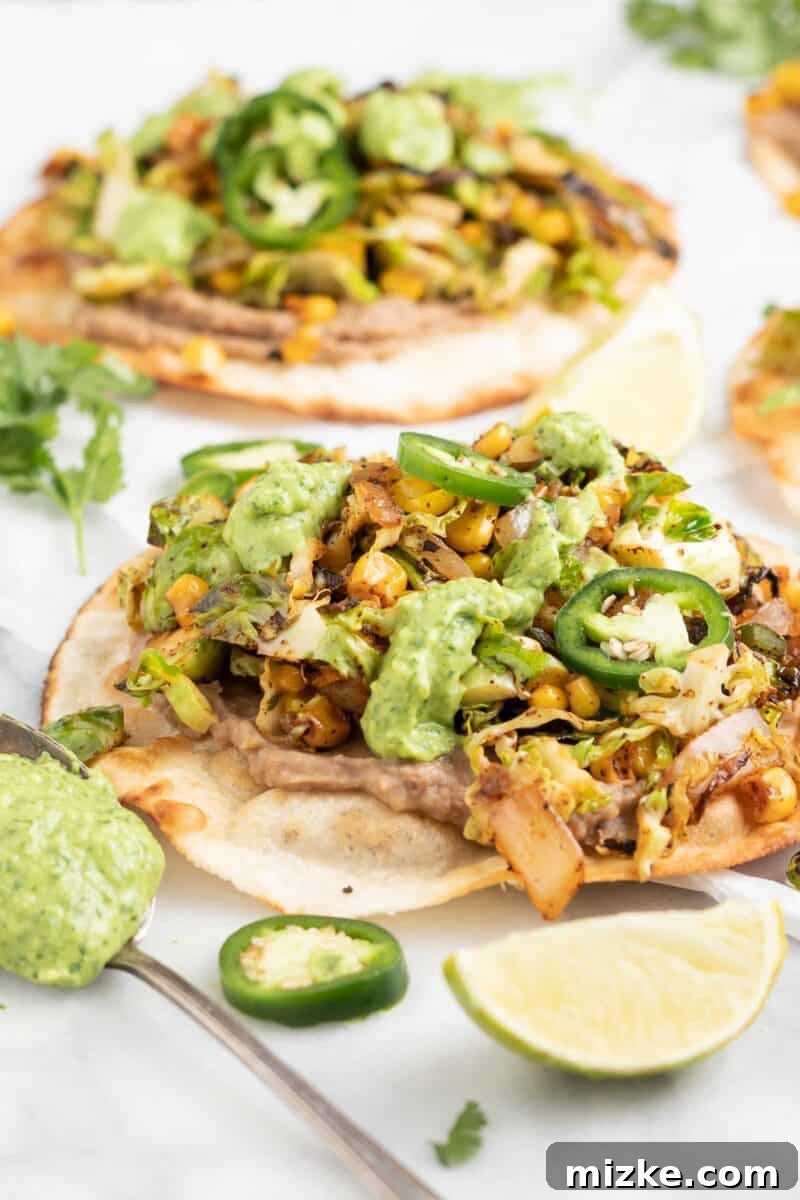 Close-up of a single Brussels Sprouts Tostada with green sauce