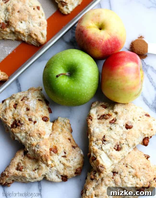 Warm Apple Cinnamon Scones 2 Freshly baked apple cinnamon scones cooling on a rack, garnished with cinnamon