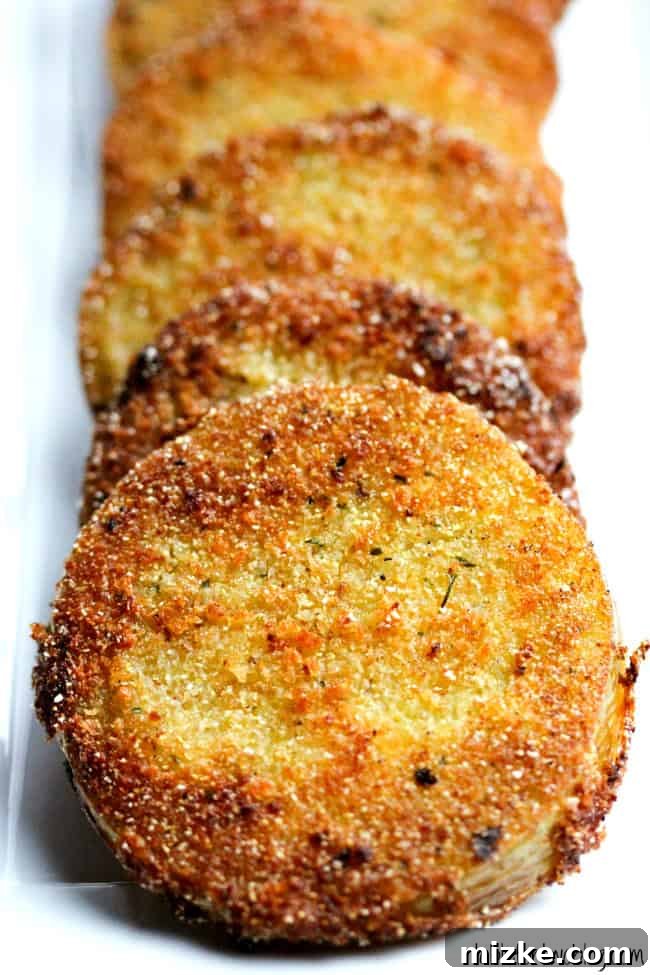 Whispers at Whistle Stop 2 A beautifully stacked plate of crispy golden fried green tomatoes, ready to be enjoyed.
