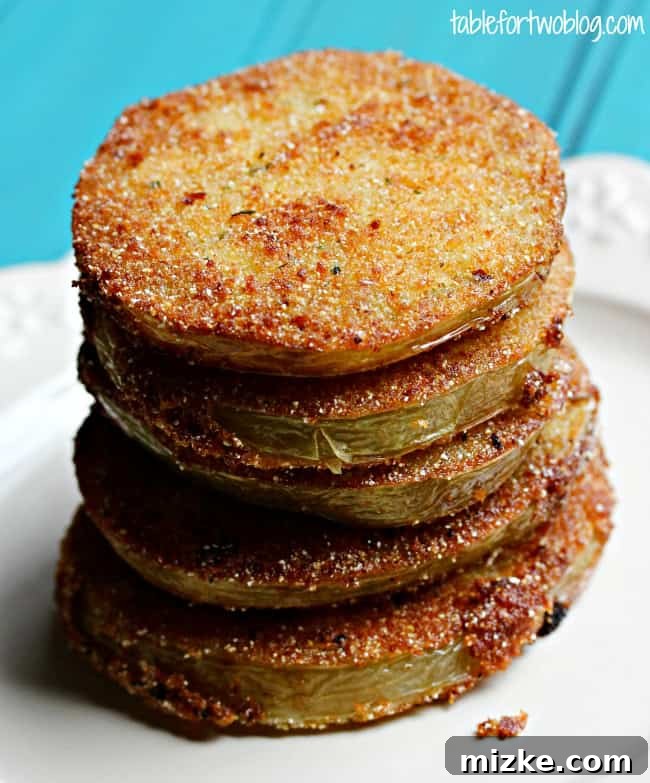 Whispers at Whistle Stop 4 A mouth-watering stack of multiple fried green tomato slices, inviting you to take a bite.