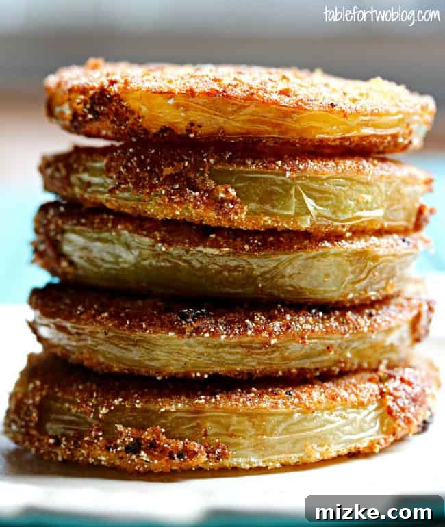 Whispers at Whistle Stop 5 Another enticing view of freshly fried green tomatoes on a plate, ready to be served.