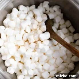 Crunchy Wreath Delights 10 Mini marshmallows added to melted butter in a pot, ready to be stirred.