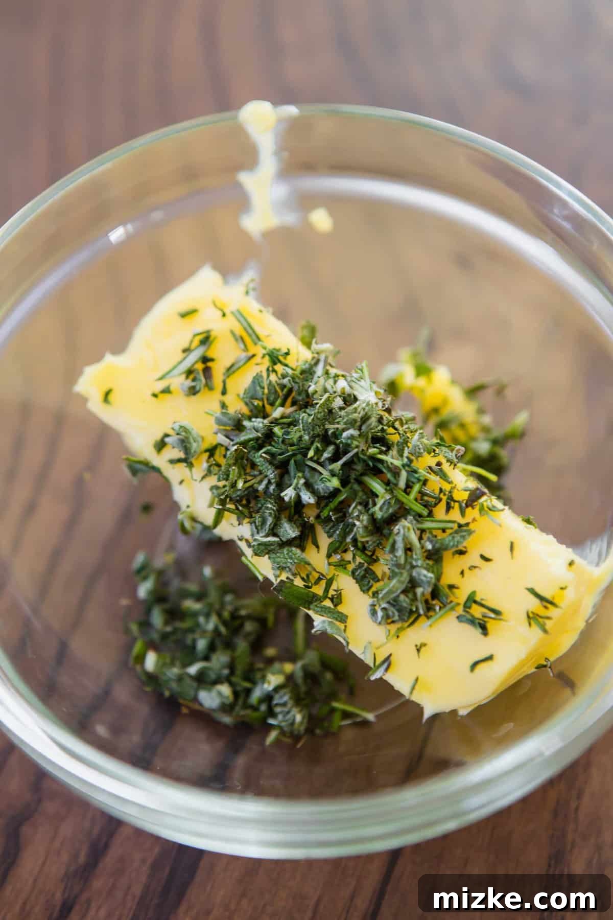 Gourmet Herb Butter 5 Stick of softened butter topped with coarsely chopped herbs in glass bowl