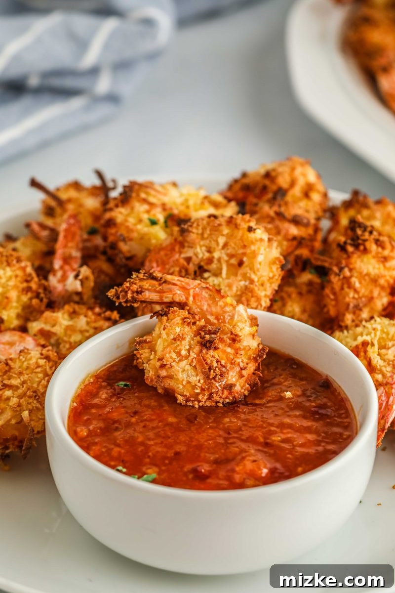 Crispy Air Fryer Coconut Shrimp 4 A plate of freshly prepared air fryer coconut shrimp, glistening and ready to be dipped.
