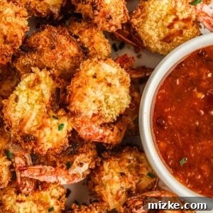 A bowl of fresh shrimp coated in coconut and panko, ready for the air fryer.