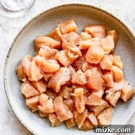 Sun-Kissed Skillet Chicken Pasta 15 Raw chicken in a bowl sprinkled with salt and ground black pepper