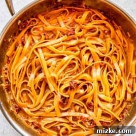 Sun-Kissed Skillet Chicken Pasta 20 Linguine pasta cooked through and in a cream sauce in a stainless steel skillet