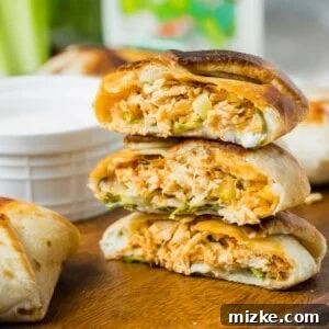 A stack of mini crunchwraps have been cut in half to reveal perfectly cooked centers.