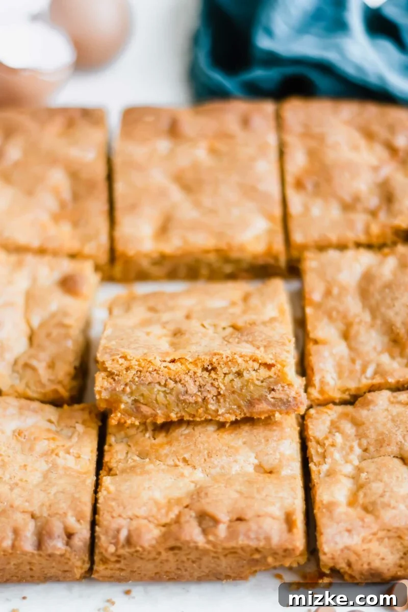 Golden Chewy Blondies 3 A close-up shot of the interior of a blondie brownie, revealing its moist and perfectly baked texture with melted butterscotch chips.