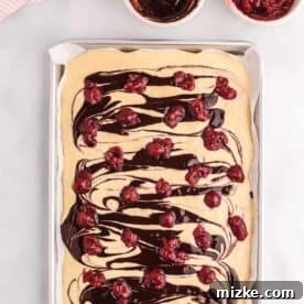 tart cherries dotted across the top of the pancake batter and chocolate sauce