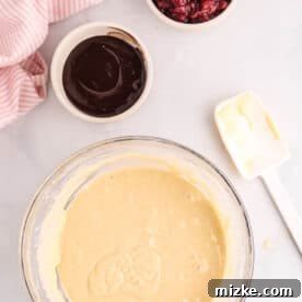 batter, chocolate sauce, and tart cherries for chocolate cherry sheet pan pancakes