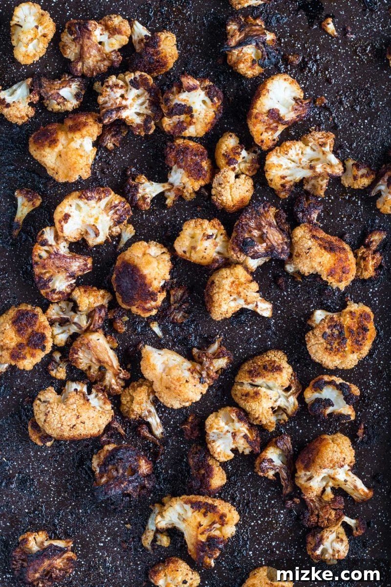 Mind-Blowing Roasted Cauliflower 3 A close-up of roasted cauliflower florets, showcasing their crispy edges and rich, golden-brown color from perfect caramelization.