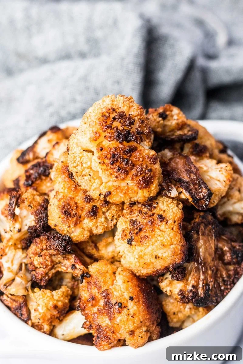 Mind-Blowing Roasted Cauliflower 5 A baking sheet filled with golden-brown roasted cauliflower florets, ready to be served as an irresistible side dish.