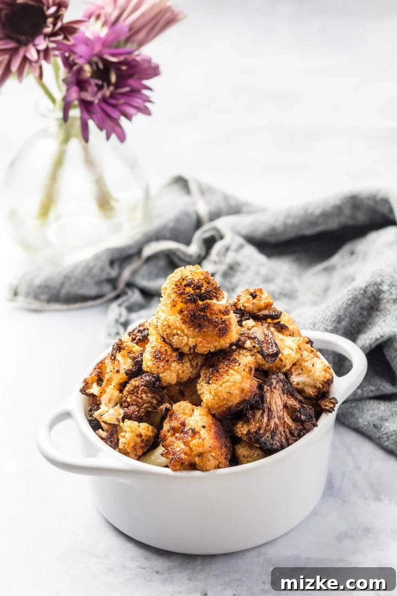 Mind-Blowing Roasted Cauliflower 6 A bowl of freshly roasted cauliflower, perfectly golden and caramelized, ready to be served as a delicious and healthy side.