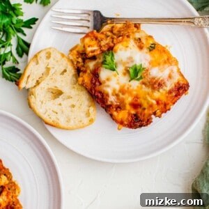 A baked ravioli lasagna with golden cheese crust in a baking dish.
